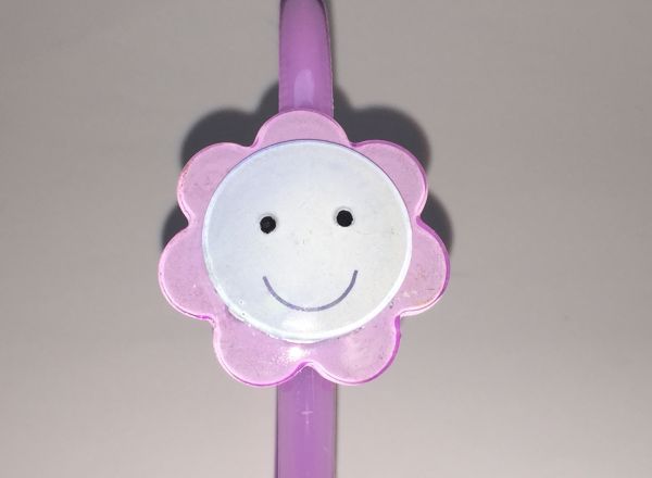 Head band with face patterned flower