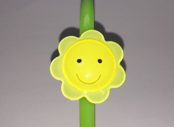 Head band with face patterned flower