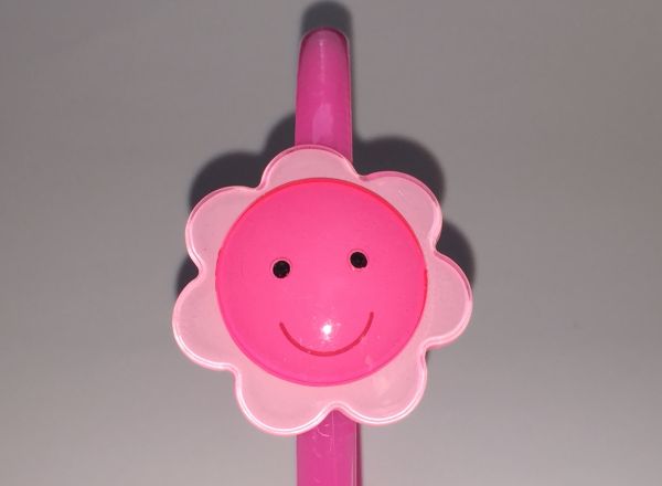 Head band with face patterned flower